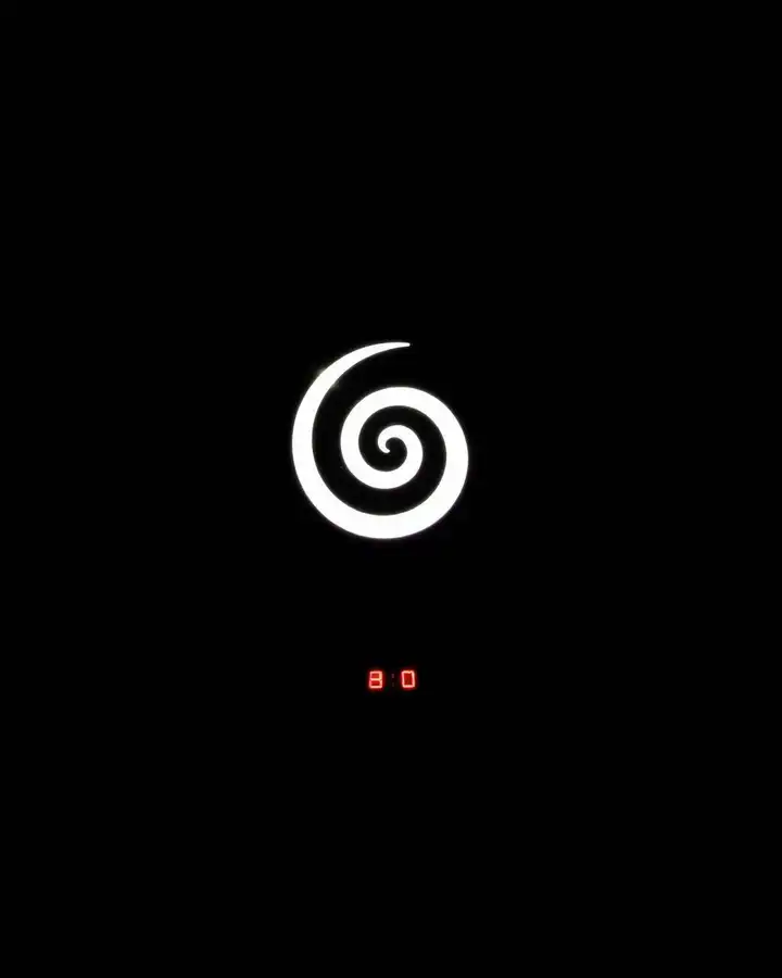 A glowing spiral symbol on a black server rack with a single red digital readout